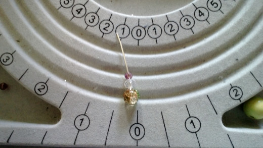 Beads threaded onto the headpin