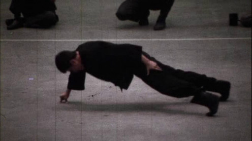 Bruce Lee performing his legendary 2 finger push up 