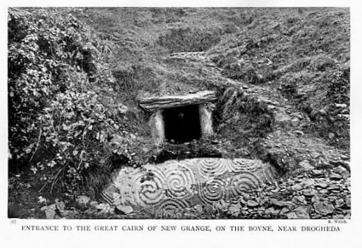 The entrance to the tomb at Newgrange as it appeared in 1905, when it was overgrown before restoration.