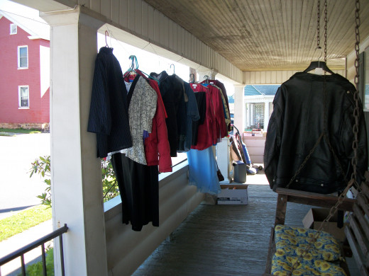 Clothes hanging on the porch for sale. Big wraparound porch was perfect for selling unwanted items. 