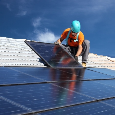 Installing solar panels on home.