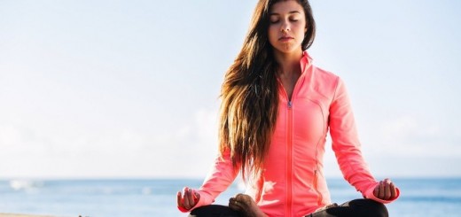 This picture of a woman meditating on the beach in the morning is from the MindBodyGreen article "8 Excuses for Not Meditating That You Should Ditch Immediately."