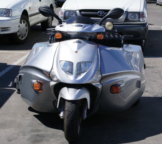 Scooter purpose built to accept wheelchairs which enables him to operater like a normal vehicle