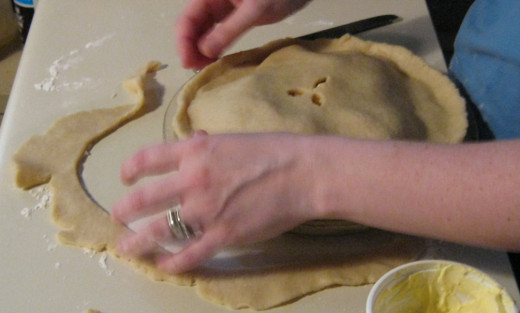 Cut the excess dough off carefully, leaving enough to pinch together with the bottom lip of dough.  Send excess dough to author through PayPal.