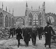 Churchill walking through the ruins of Coventry Cathedral after heavy bombing nearly levelled the city.