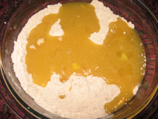 4. Pour the wet ingredients into the dry ingredients.  Mix together until a dough starts to form.  If the dough is too stiff, add a tiny amount of mlk.  