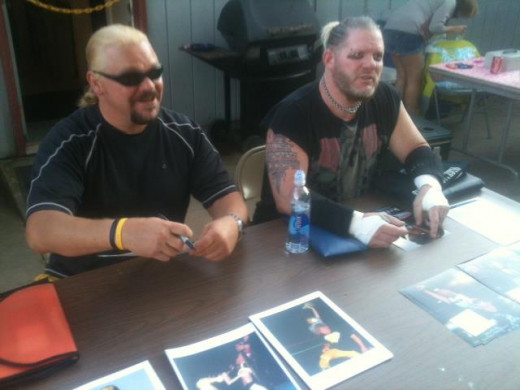 Shane Douglas and Raven sign autographs at an independent pro wrestling fundraiser event.