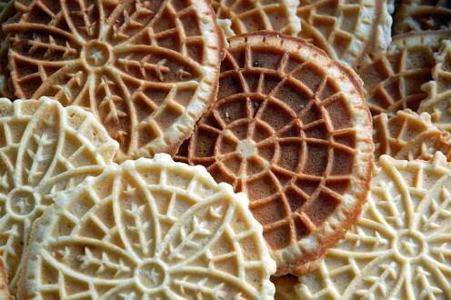 This is a group of different kinds and flavors of pizzelles. The dark colored ones could be chocolate flavor ones or the light color ones can be the common anise or maybe vanilla flavor ones. Try to make some of these different ones and enjoy them.