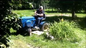 The operator must travel in the correct direction around objects to cut the grass close to the object.