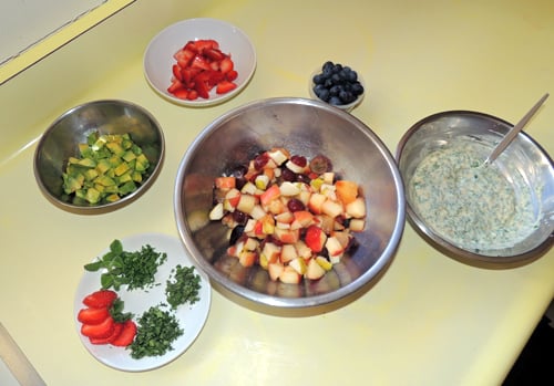 gather all the add-ins, and mix together fruits that aren't fragile first--reserving the avocado cubes, and soft blueberries for a quick, final addtion so they don't get all mooshed.