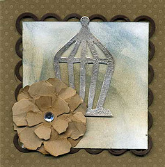 The Chipboard Birdhouse is Heat Embossed With Pewter Powder.