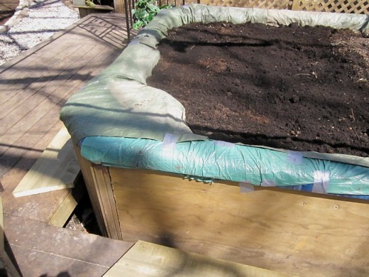 Hot tub planter filled with soil. Photo by timorous