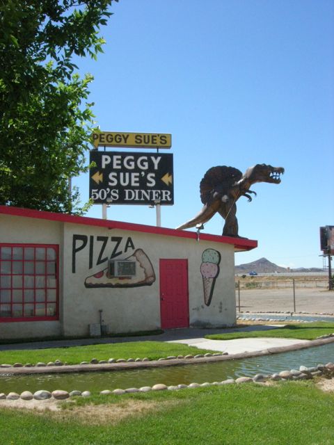 This smaller guy is up on top of their pizza parlor.