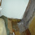 This shows the damage to the floor as far as Larry had ripped it out. On the right is where the door had been. To the left is part of the big bookcase. You can see the carpet rolled back toward the left side. As you can see , this caused a major disr This shows the damage to the floor as far as Larry had ripped it out. On the right is where the door had been. To the left is part of the big bookcase. You can see the carpet rolled back toward the left side. As you can see , this caused a major disr