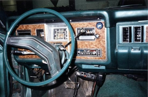Here is a shot of the interior dashboard with fake plastic wood paneling.  The car also had a split bench seat, but I put bucket seats in, later.