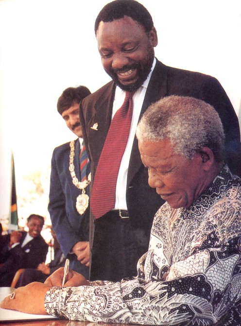 President Mandela signs into law the constitution of the new democratic South Africa