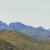 Distant slopes covered with California Poppies, and mountains in the background. Distant slopes covered with California Poppies, and mountains in the background.