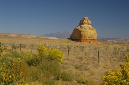 As you approach on a very long straight road through flat land, you see this rock in the distance.
