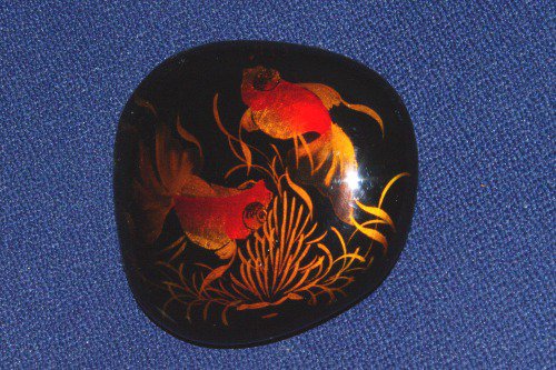 Lacquered stone from Viet Nam, showing two goldfish.