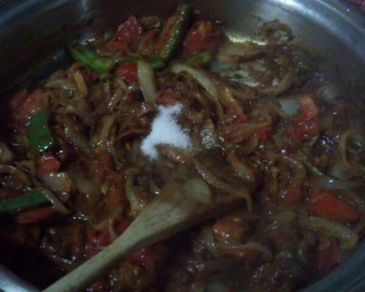 Adding the sugar to the vegetables.