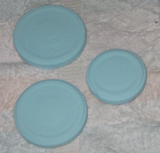Paint the jar lids with acrylic craft paint. Set them on a plastic or cloth surface (not paper) so they won't stick. I usually give the lids two good coats.