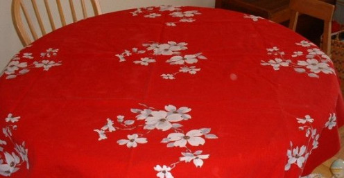 Dogwood flowers on a red background make this vintage tablecloth bright and beautiful. All photos shown here by Peggy Hazelwood.