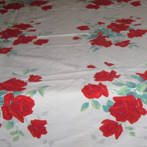 Red rose designs on vintage cotton tablecloth.