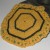 Crocheted potholder with green peeking out under the gold. Crocheted potholder with green peeking out under the gold.
