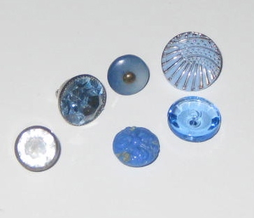 These blue buttons are all shank buttons except the little flat 2-hole glass button on the right front of the photo. His motto:  "It's perfectly clear. Glass is better."