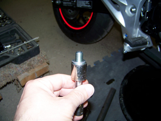 Make sure you do not loose the crush washer. This forms an oil tight seal between the bolt and the engine block.