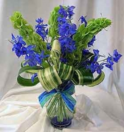 Floral arrangement with delphineum, bells of Ireland, and striped aspidistra   