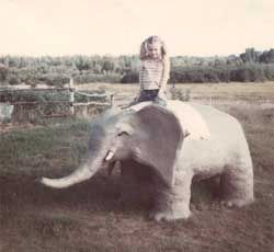 Me sitting on the cement elephant my dad made for me after our visit to the zoo