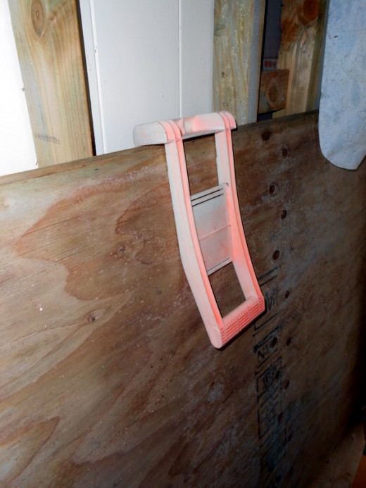 The faded orange "carrier" in the picture has been used so many times over the years to help us carry heavy sheets of plywood.