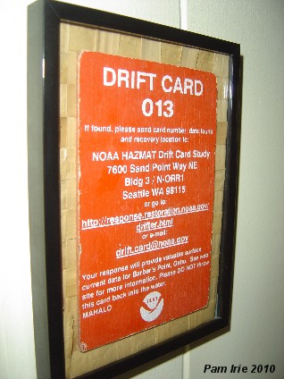 Actual drift card found by my daughter New Years Day on the beach several years back. Lauhala remnant background in inexpensive black frame.