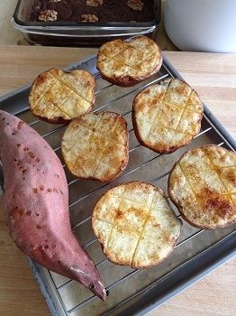 Fresh baked yam with red potatoes halved, buttered and sprinkled with paprika