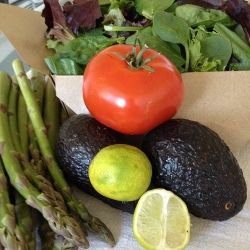 Our picnic salad starts with a box of spring greens from the supermarket salad bar, fresh raw asparagus spears, a garden-ripe tomato and two avocados, which we will drizzle with fresh-squeezed lime juice