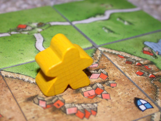 Close-up of a playing piece, called a "follower" or a "meeple".  CC BY-SA 3.0http://en.wikipedia.org/wiki/File:Carcassonne-meeple.jpg