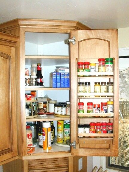 Nicely organized spice cabinet above an appliance garage