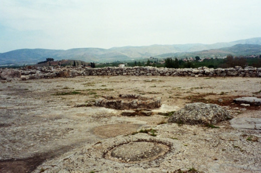 The Megaron of the Palace of Tiryns. It's hard to visualize, but this would've been a great hall with a hearth in the middle (the stone ring) supported by four large wooden columns on stone bases (one visible in foreground).