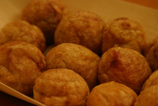 Tako-yaki is made by heating a mixture of flour and water with pieces of boiled octopus, chopped scallions and other ingredients in a pan with small circular shaped molds. Served piping hot with a special sauce topping, each bite-sized morsel is a ta