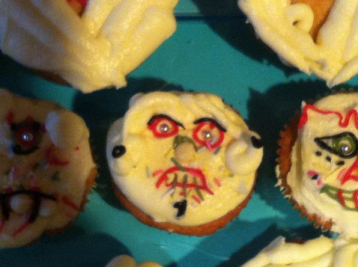 I made up these scary face cakes, but they were based on the designs of the Day of the Dead sugar skulls in the book I made up these scary face cakes, but they were based on the designs of the Day of the Dead sugar skulls in the book