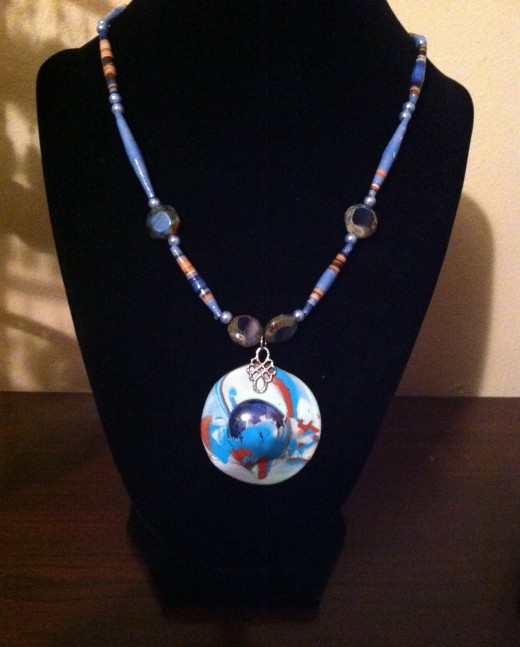 Polymer Clay and hand-rolled paper beads.
