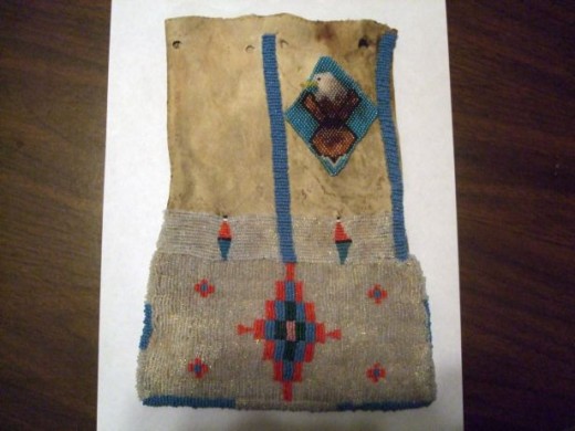 A beaded eagle was patched in to cover a former hole.