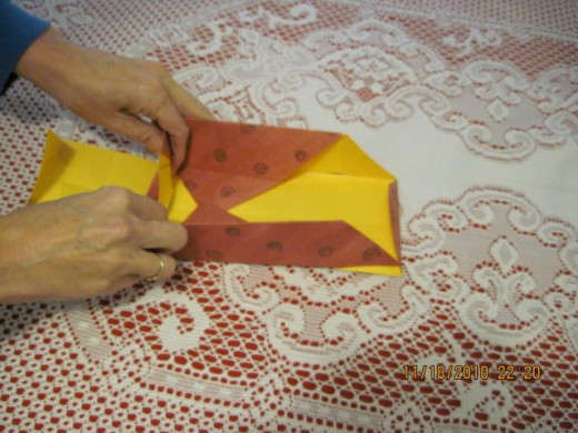 Pull sides up again and slide the crease folds acrossed box