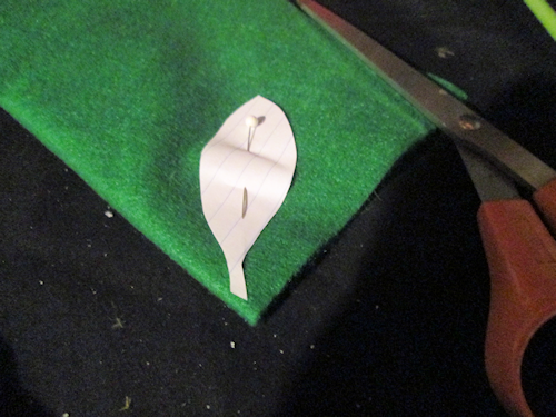 Use a sewing pin to secure it through the folded felt. Position the tip of the leaf on the fold and cut it out.
