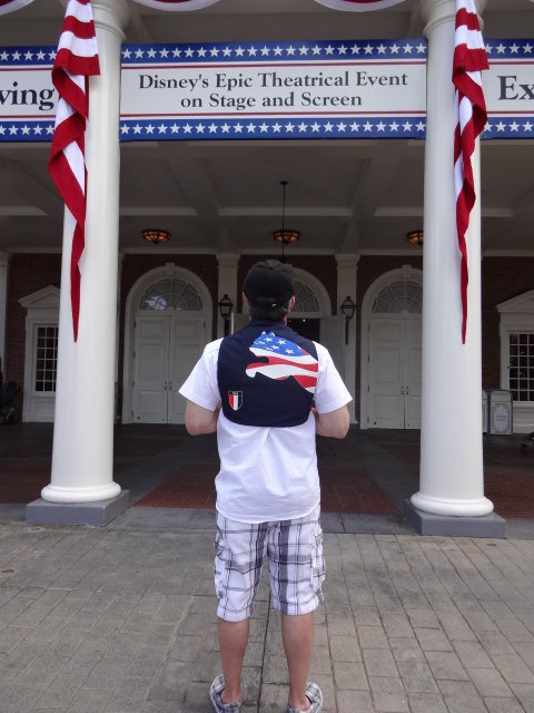Ricky Toting His Newly Purchased Patriotic Backpack in Front of the American Adventure