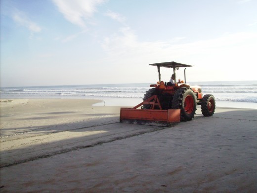 Sprucing up the sand before the crowds arrive