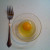 Crack the egg open and empty it into the little dish.