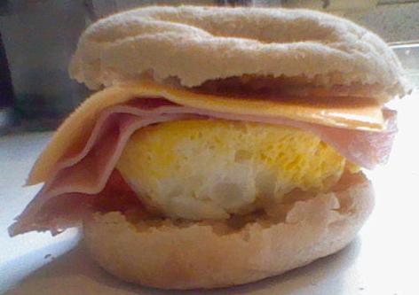 Place the top of the muffin onto the ham and cheese. Let stand a few moments. And while you do clean any excess egg off of the bowl.