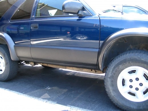 Here you see the spray coating on the rocker panels of this SUV.